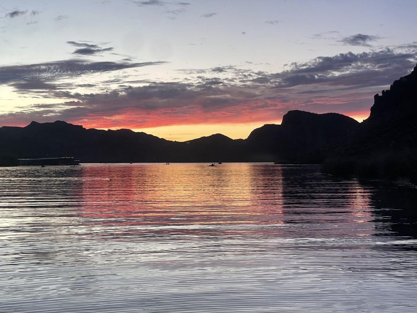Sunset reflecting on the water with paddlers in the distance